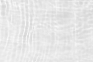 Bluewater waves on the surface ripples blurred. Defocus blurred transparent blue colored clear calm water surface texture with splash and bubbles. Water waves with shining pattern texture background. photo