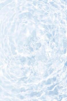 Blue water with ripples on the surface. Defocus blurred transparent blue colored clear calm water surface texture with splashes and bubbles. Water waves with shining pattern texture background. photo