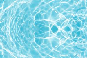 Bluewater waves on the surface ripples blurred. Defocus blurred transparent blue colored clear calm water surface texture with splash and bubbles. Water waves with shining pattern texture background. photo