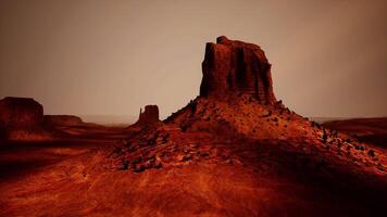 A large rock formation in the middle of a desert video