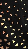 Animated 3D waving cloth texture with orange and black stripes and triangles, seamless loop. Motion. Smooth silk cloth surface with ripples and folds in tissue. video