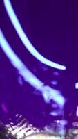 Close up of empty transparent glass being filled with green soda water. Stock clip. Wall with colorful illumination of a night bar. video