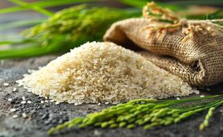 A bag of rice is on a table next to a bunch of green rice photo