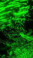 Black background. Design.Different sizes of green light color glitters in different parts of the backgrounds fly to different places. video