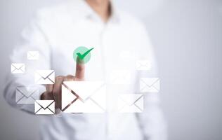 Businessman sending email by laptop computer to customer, business contact and communication, email icon, email marketing concept, send e-mail or newsletter, online working internet network. photo