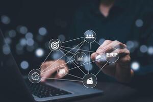 Business people using a laptop with document management for ERP. Enterprise resource planning concept,Enterprise Resource Management ERP software system for business resources plan presented. photo