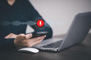 Businessman using mobile and touch microphone button on virtual screen. Blog blog speak talk advertising presentation,Voice recognition, speech detection and deep learning application,Voice Assistance photo