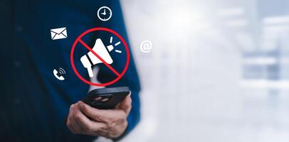 Businessman using smartphone touch mute icon on virtual screen. Blog blog speak talk advertising presentation,Voice recognition, speech detection and deep learning application,Voice Assistance photo