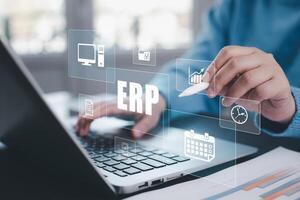 Business people using a laptop with document management for ERP. Enterprise resource planning concept,Enterprise Resource Management ERP software system for business resources plan presented. photo