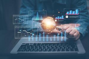 Businessman using a laptop with Analytics and Data Management Systems Analyst working in Business Analytics and Data Management Systems to make reports and corporate strategy for finance, operations photo