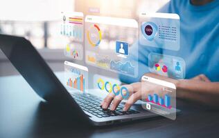 Businessman using a laptop with Analytics and Data Management Systems Analyst working in Business Analytics and Data Management Systems to make reports and corporate strategy for finance, operations photo