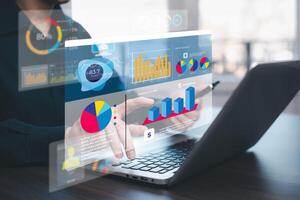 Businessman using a laptop with Analytics and Data Management Systems Analyst working in Business Analytics and Data Management Systems to make reports and corporate strategy for finance, operations photo