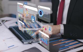 Businessman using a laptop with Analytics and Data Management Systems Analyst working in Business Analytics and Data Management Systems to make reports and corporate strategy for finance, operations photo