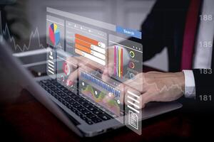 Businessman using a laptop with Analytics and Data Management Systems Analyst working in Business Analytics and Data Management Systems to make reports and corporate strategy for finance, operations photo