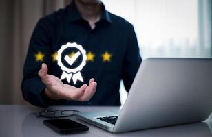 Quality assurance of business services, Businessman Hand shows the sign of the top service Quality assurance in Black background , Guarantee, Standards, ISO certification and standardization concept. photo