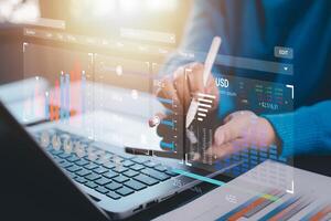 Businessman using a laptop with Analytics and Data Management Systems Analyst working in Business Analytics and Data Management Systems to make reports and corporate strategy for finance, operations photo