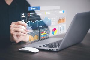Businessman using a laptop with Analytics and Data Management Systems Analyst working in Business Analytics and Data Management Systems to make reports and corporate strategy for finance, operations photo