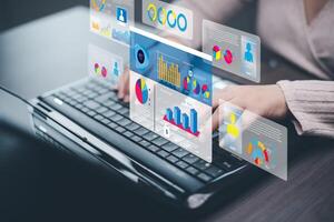 Businessman using a laptop with Analytics and Data Management Systems Analyst working in Business Analytics and Data Management Systems to make reports and corporate strategy for finance, operations photo