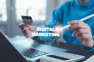 A businessman is using a laptop to create digital marketing content.Creating marketing strategies involves sharing information to attract customer interest.Online marketing and digital marketing. photo