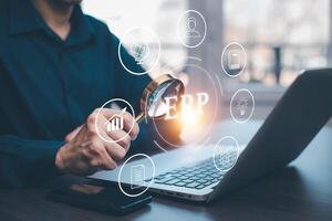 Business people using a laptop with document management for ERP. Enterprise resource planning concept,Enterprise Resource Management ERP software system for business resources plan presented. photo