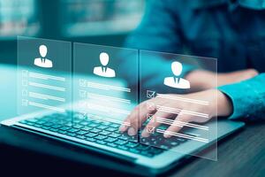 businessman using laptop with Personal information file storage concept ,HR checklists of employees Corporate data management system and document management system with employee privacy. photo