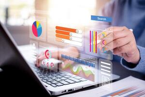 Businessman using a laptop with Analytics and Data Management Systems Analyst working in Business Analytics and Data Management Systems to make reports and corporate strategy for finance, operations photo