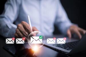 Businessman sending email by laptop computer to customer, business contact and communication, email icon, email marketing concept, send e-mail or newsletter, online working internet network. photo