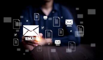 Businessman sending email by laptop computer to customer, business contact and communication, email icon, email marketing concept, send e-mail or newsletter, online working internet network. photo