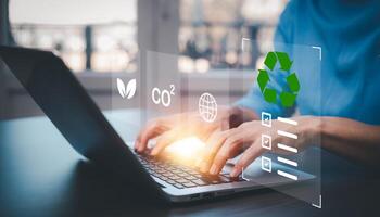 Businessman using laptops and touch recycle symbol with virtual modern reduce CO2 emission concept with icons, global warming emissions carbon footprint climate change to limit global warming, energy photo