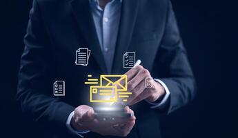 Businessman sending email by laptop computer to customer, business contact and communication, email icon, email marketing concept, send e-mail or newsletter, online working internet network. photo