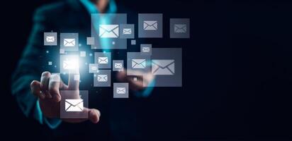 Businessman sending email by laptop computer to customer, business contact and communication, email icon, email marketing concept, send e-mail or newsletter, online working internet network. photo