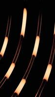 Black background. Design. Bright lines with lanterns and orange shades in them sparkle and shimmer with different colors in abstraction video