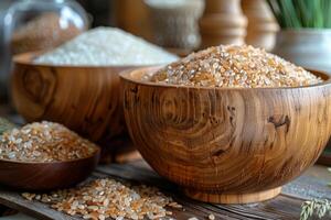 Different types of rice in bowls on wooden table photo