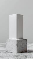 Minimalist white rectangular block on marble cube stand. Modern abstract geometric sculpture with clean lines and neutral tones. photo
