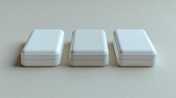Three white rectangular plastic containers arranged in a row on a light gray surface, minimalistic and clean design. photo