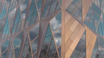 Russia, Yekaterinburg - May 13, 2022. Top view of modern architecture of office building. Stock footage. Glass windows with stylish design of architecture of modern building. Headquarters of Russian video