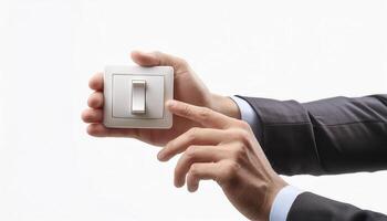 A person in a business suit turning on a light switch against a white background, highlighting energy conservation and professional office setting. photo