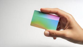 Hand holding a shiny gradient card on a white background, showcasing vibrant colors and minimalistic design, perfect for branding or business use. photo