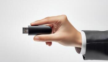 Hand holding a black USB flash drive on a white background, highlighting portable data storage and technology concepts. photo