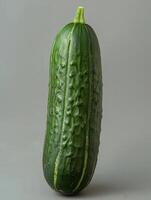 Fresh Green Cucumber on Gray Background photo