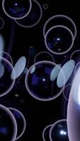 Black background. Design. Large white bubbles in animation on a dark background scatter in different directions. video