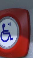 Close-up button for disabled people. Media. Help button for people with disabilities. Button to help disabled people in public transport video