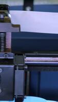 Close-up of moving machine in 3d printer. Media. Creating objects on 3D printer with machine. Process of operation of 3d printer machine during printing video