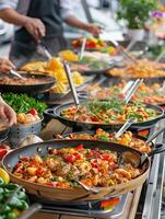 A vibrant buffet of delicious, colorful dishes being served at an outdoor event, showcasing a variety of fresh ingredients and culinary skills. photo