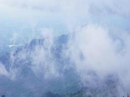 A foggy mountain landscape with mist enveloping the peaks, creating a serene and mystical atmosphere. video
