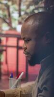 Vertical Entrepreneur reviews business updates and details at his home, allocating resources and finishing operations tasks to achieve strategic goals, money management remote work. Camera A. video