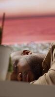 Vertical Entrepreneur sleeping on his home office desk after stressful analysis for the online business he is running. Tired fatigued businessman getting some rest with a nap, burnout. Camera A. video