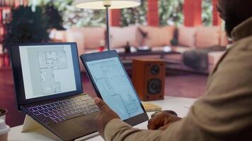Entrepreneur planning an office relocation evaluating architectural blueprints, consulting with interior designers to create an inspiring workspace. Hunting for property leasing. Camera B. video