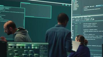Governmental hackers analyzing cyber threats on big screens, managing important database hacking activity in high tech agency office. Work on cyber defense to protect national security. Camera A. video
