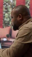 Vertical Businessman evaluating architectural blueprints for a modern office space, using strategic planning new commercial workspace leasing for his startup. Hunting for real estate property. Camera A. video